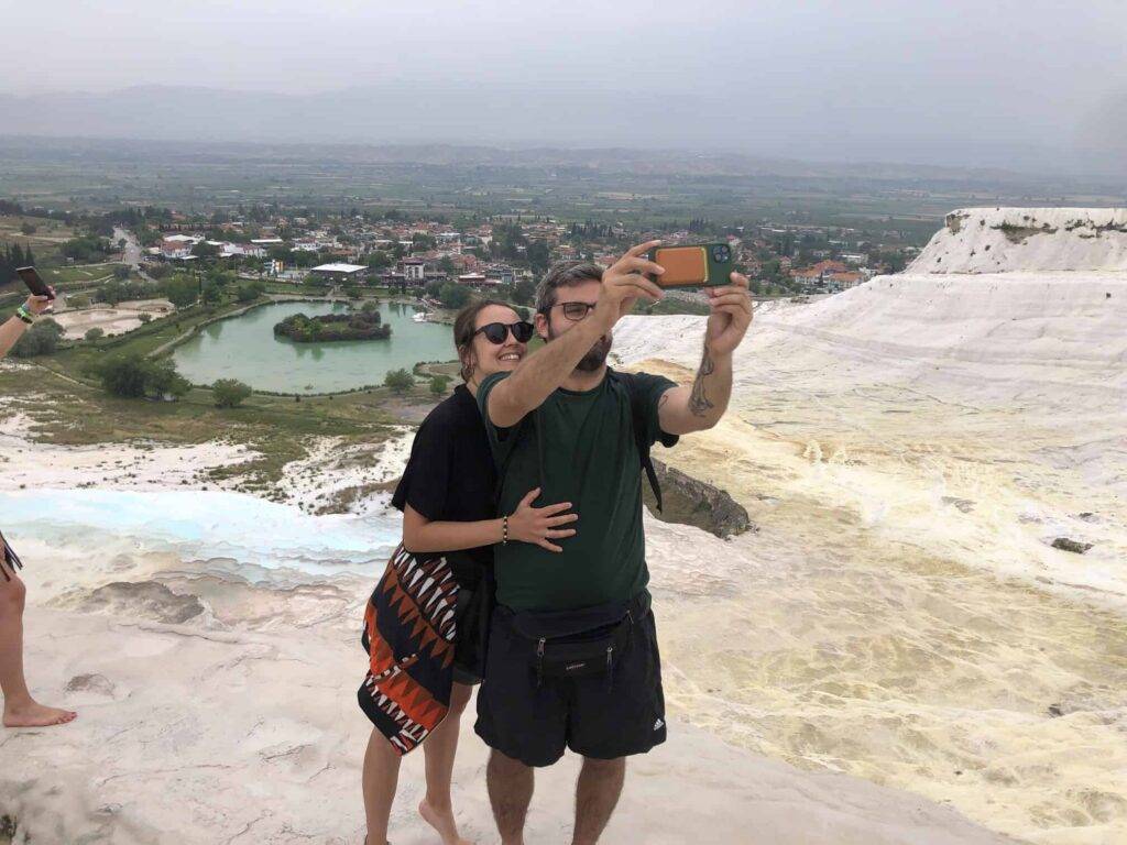 A couple taking a selfie in Pamukkale travertines