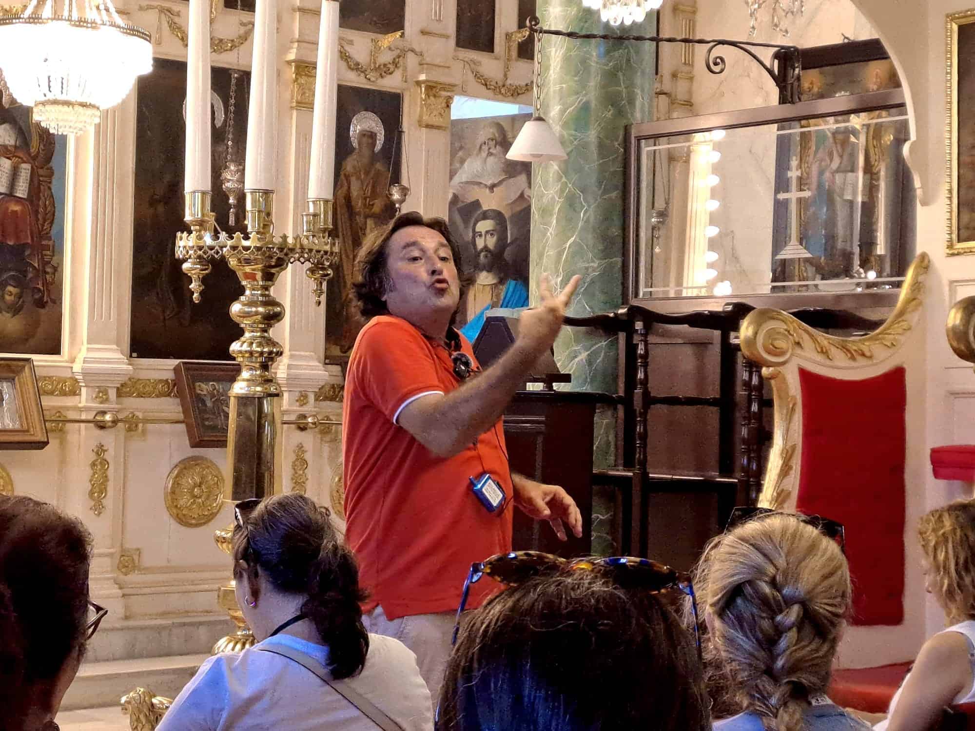 Ahmet Faik Ozbilge guiding guests inside a church in Istanbul