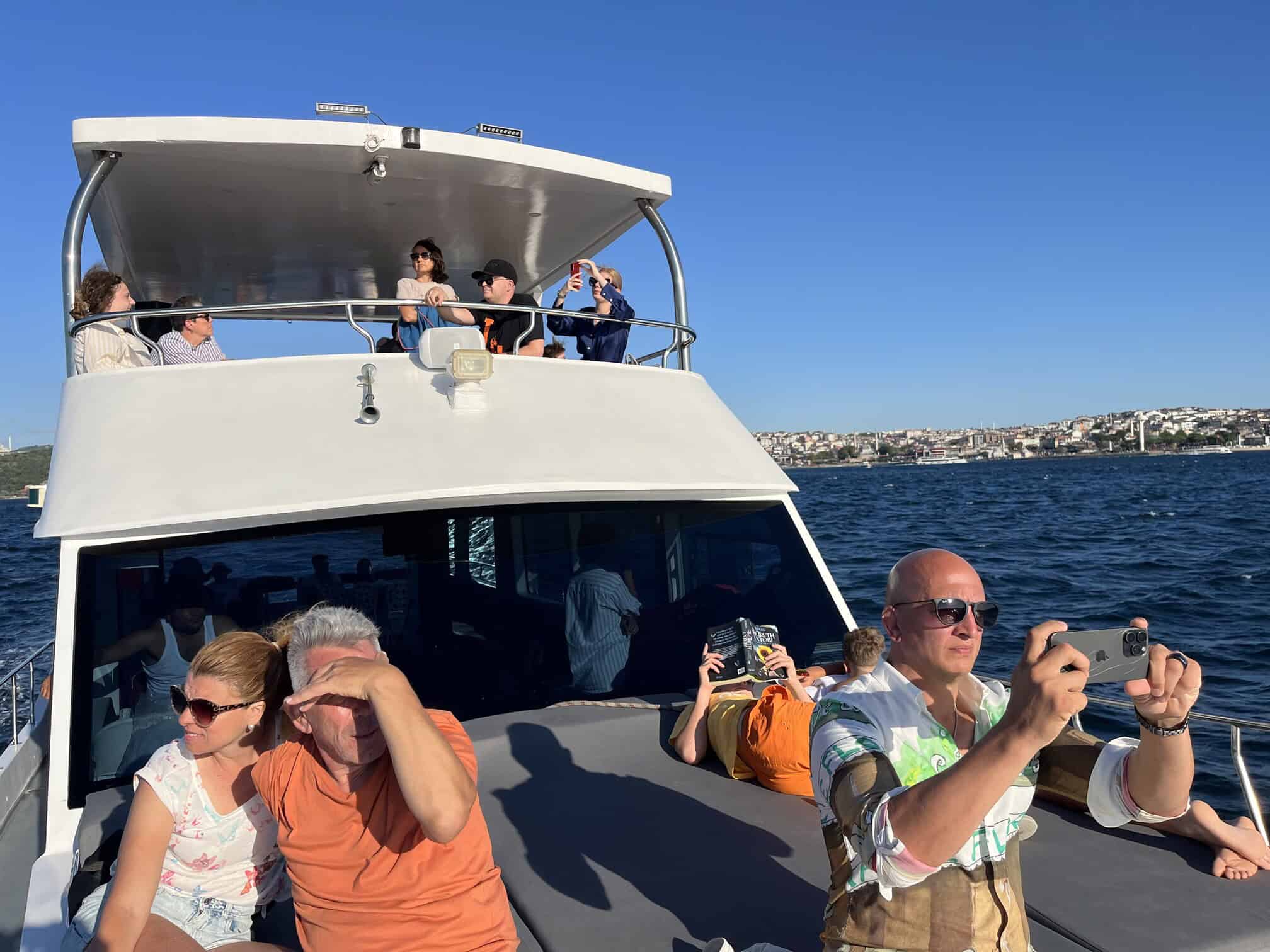 Guests on the deck of a private boat under way on the Bosphorus