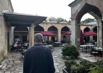View of the tranquil central courtyard of Caferağa Medresesi in Istanbul, with stone arcades and art studios welcoming visitors.