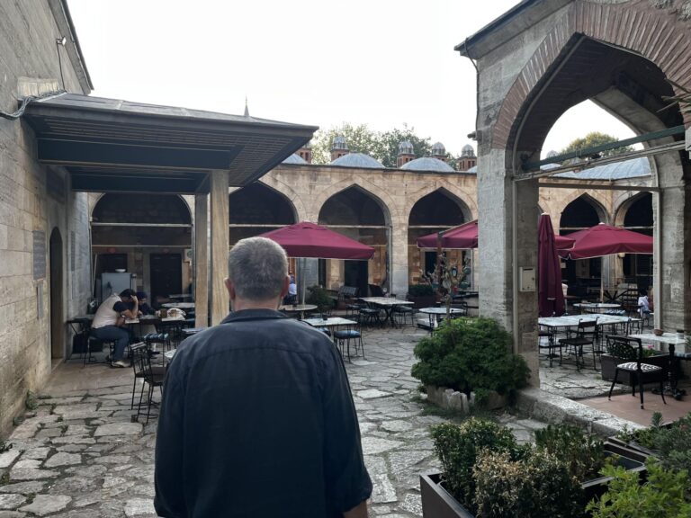 View of the tranquil central courtyard of Caferağa Medresesi in Istanbul, with stone arcades and art studios welcoming visitors.