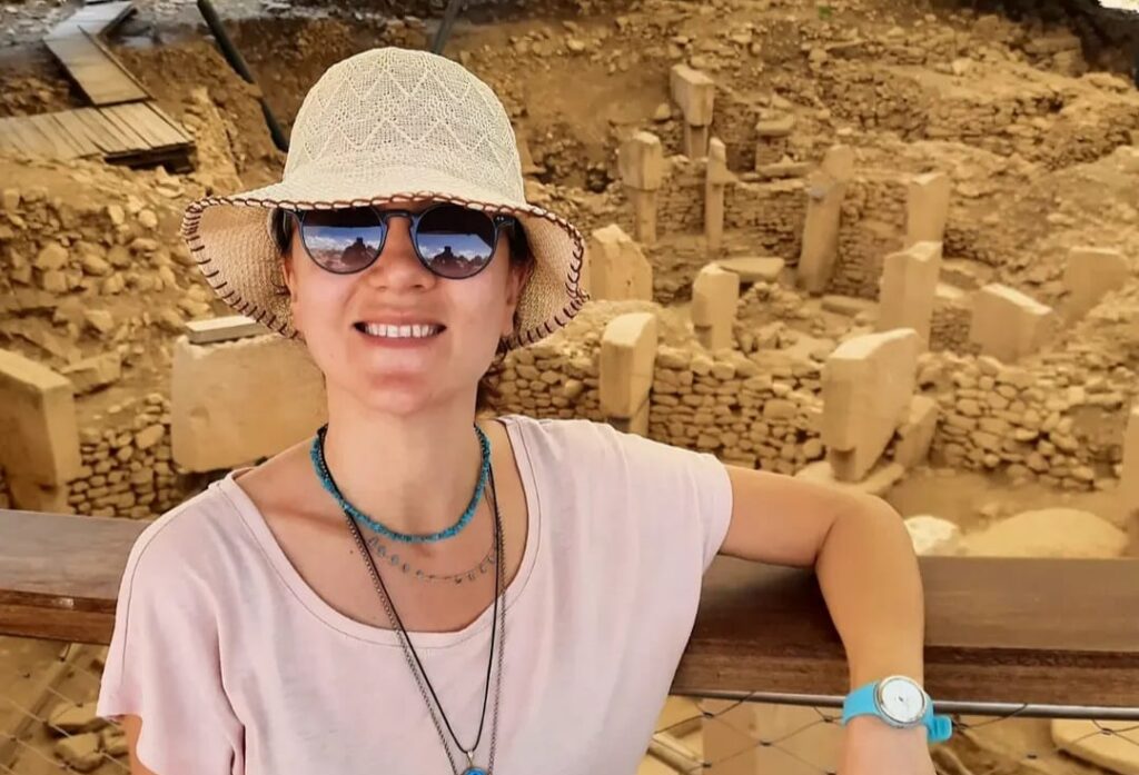 Betül Başak at the Göbeklitepe excavation with T-shaped pillars