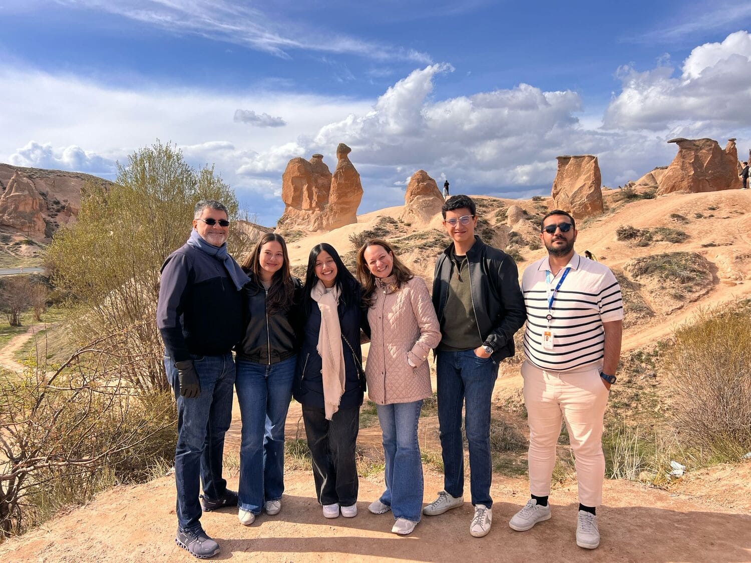 Aziz Acar with six guests below the camel rock in Devrent Valley