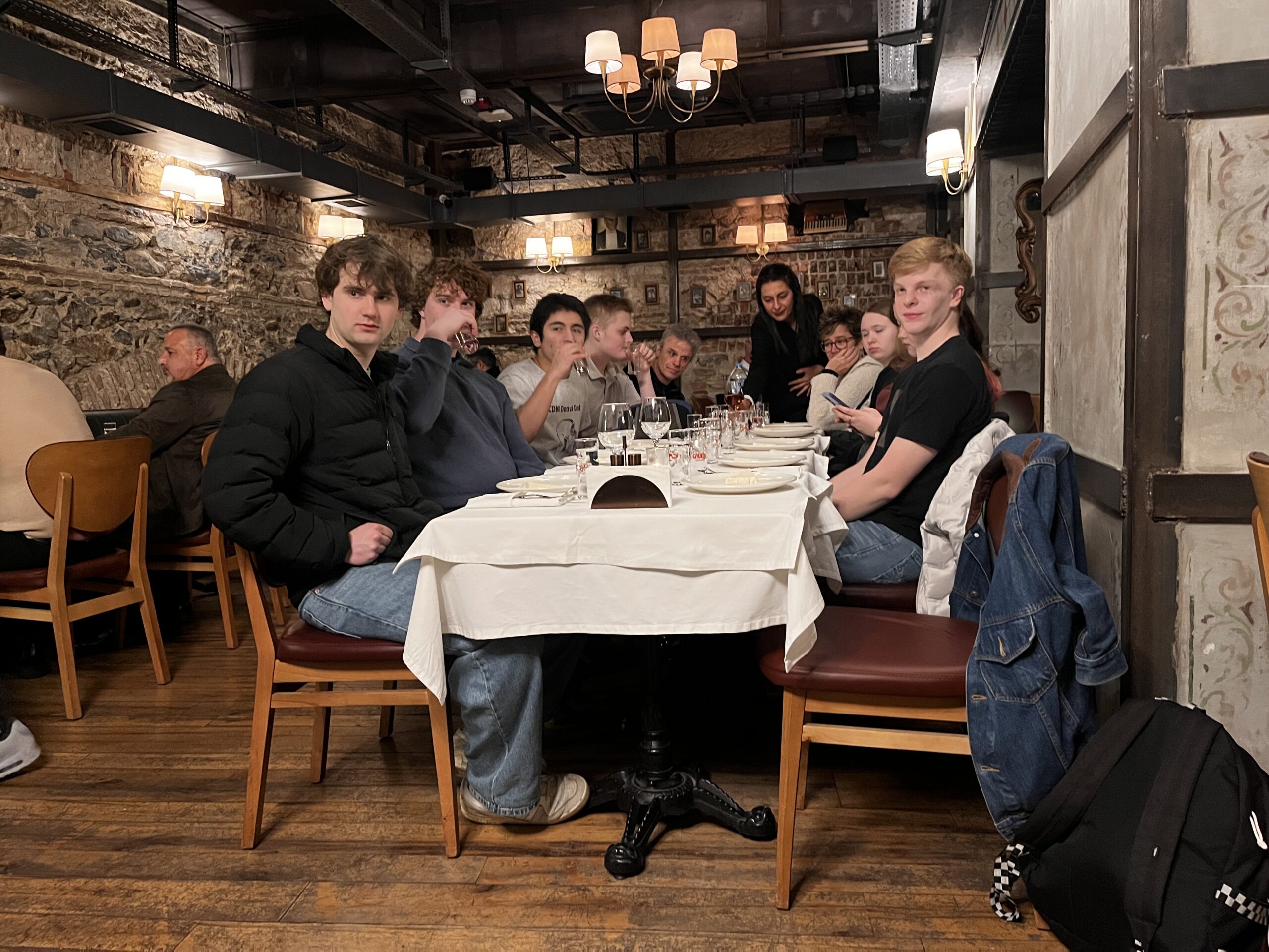 One long table in an Istanbul meyhane, meze down the middle and the group talking across it