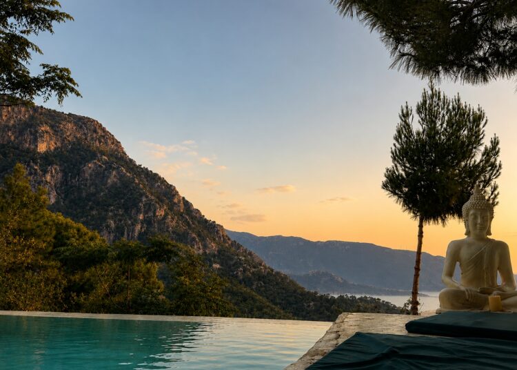 Sunset view of Kabak Bay with turquoise water and rugged Mediterranean coastline near Fethiye, Türkiye.