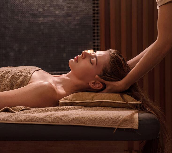 Therapist performing professional head and neck massage on guest in Karaköy hamam spa room