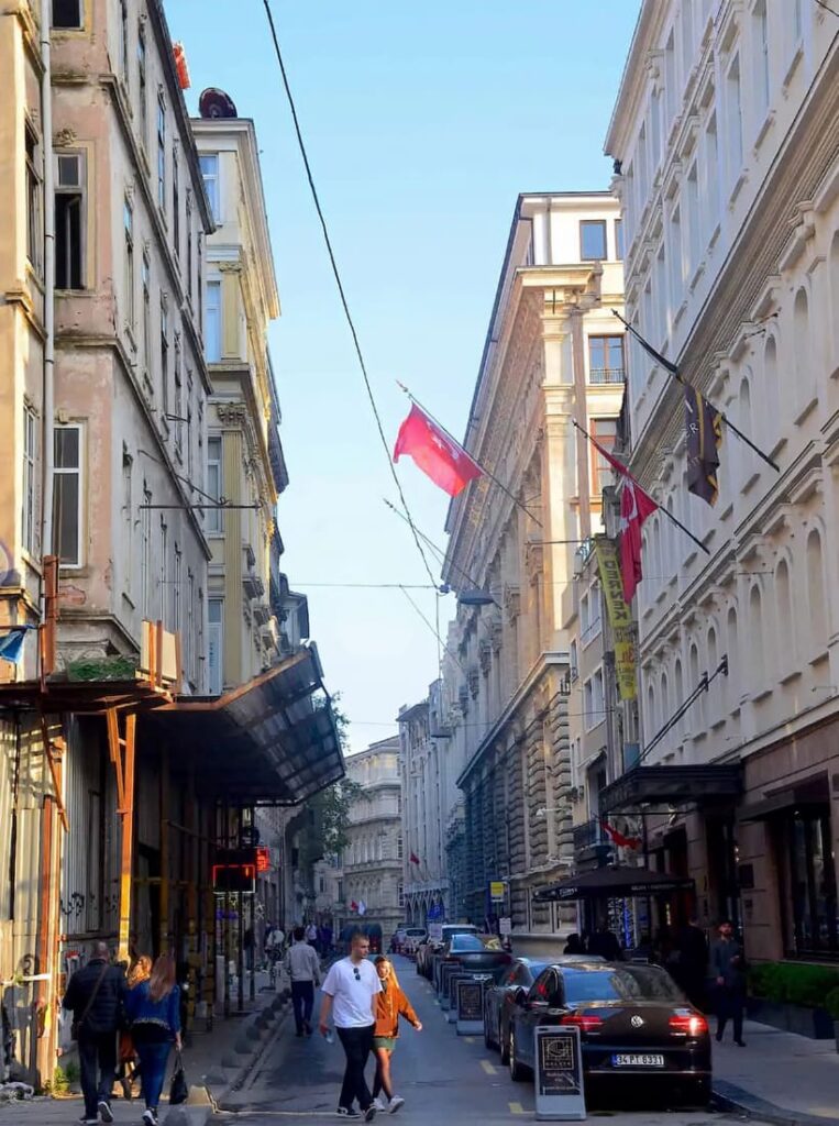 Pedestrians walking a historic Beyoğlu street in Karaköy neighbourhood near Tarihi Çeşme Hamamı