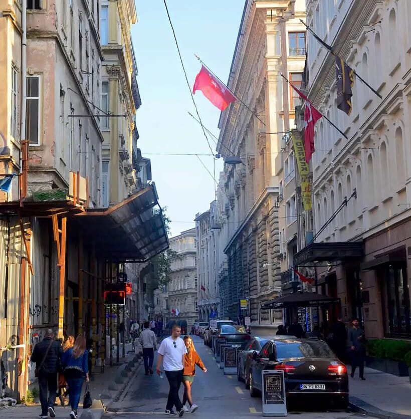 Pedestrians walking a historic Beyoğlu street in Karaköy neighbourhood near Tarihi Çeşme Hamamı