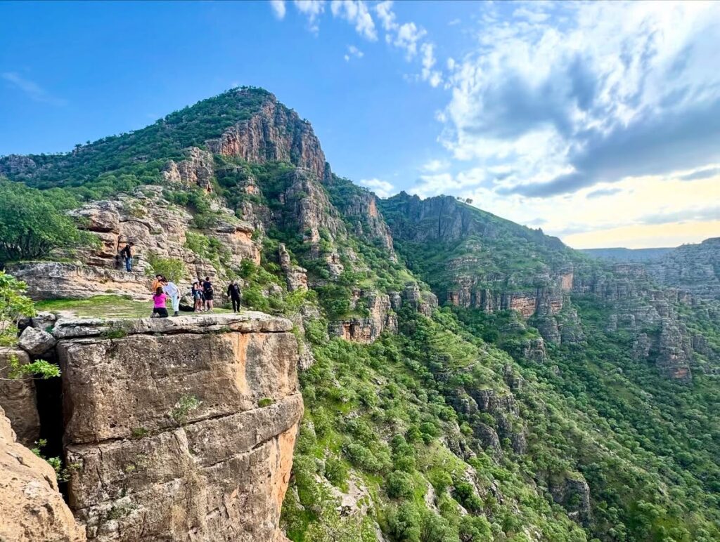 Visitors enjoying the panoramic viewpoint overlooking Cehennem Deresi Canyon in Şırnak, Turkey.