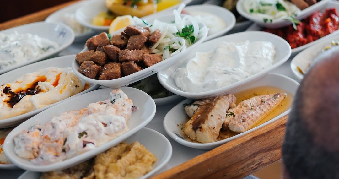 A selection of traditional Turkish meze, including seafood, yogurt appetizers, haydari, hummus, and grilled liver at İsmet Baba Restaurant in Istanbul