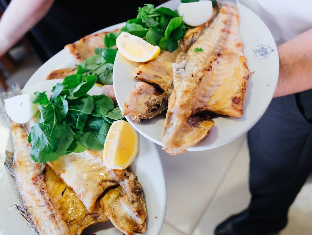 Freshly grilled whole fish served with lemon and seasonal greens at İsmet Baba Restaurant, a renowned Bosphorus seafood restaurant in Istanbul