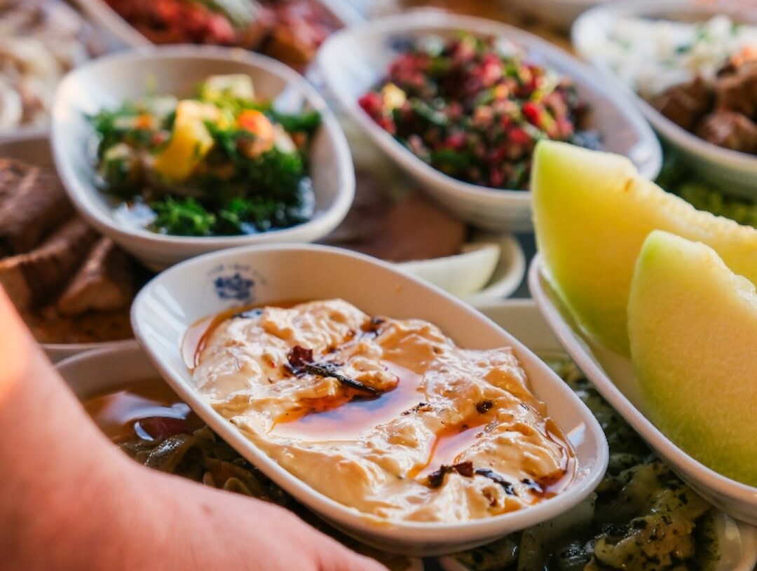 A selection of traditional Turkish meze including atom, hummus, herb salad, and seasonal appetizers served at İsmet Baba Restaurant in Istanbul