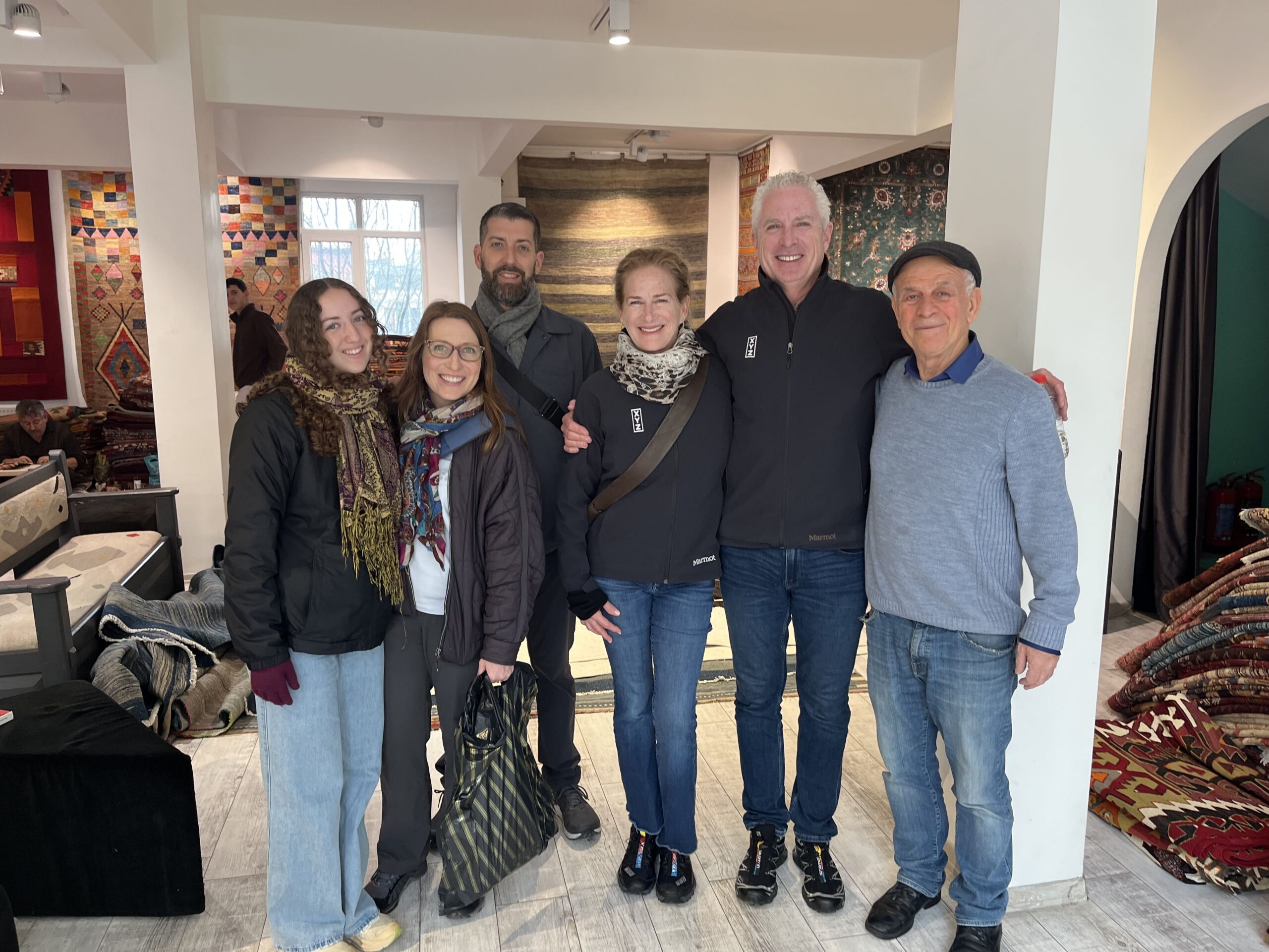 Ahmet Diler posing with visitors after a guided tour at Kirkit Rugs in Sultanahmet, Istanbul.