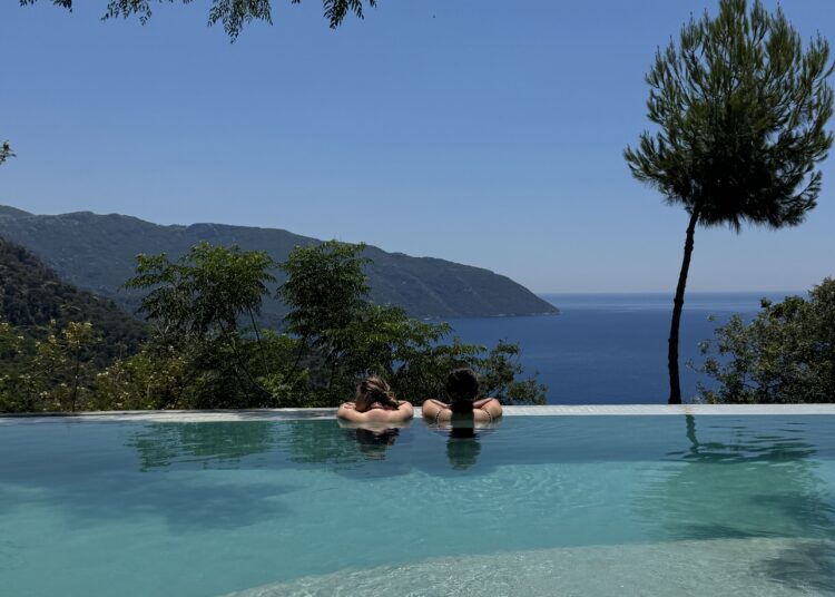 Infinity pool overlooking the Mediterranean Sea and the mountains of Kabak Valley near Fethiye, Türkiye.