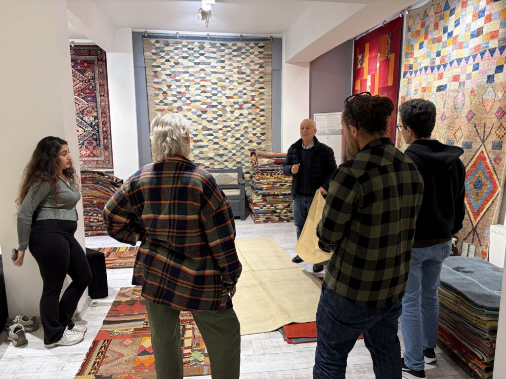 Visitors attending a guided presentation on traditional Turkish kilims and weaving techniques at Kirkit Rugs in Sultanahmet, Istanbul.