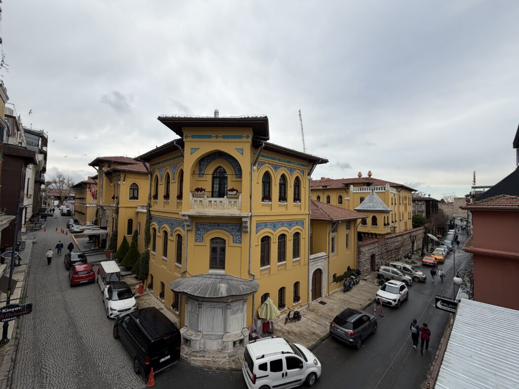 Historic yellow building on Kutlugün Street in Sultanahmet, Istanbul, home to Kirkit Rugs near Hagia Sophia and the Blue Mosque.
