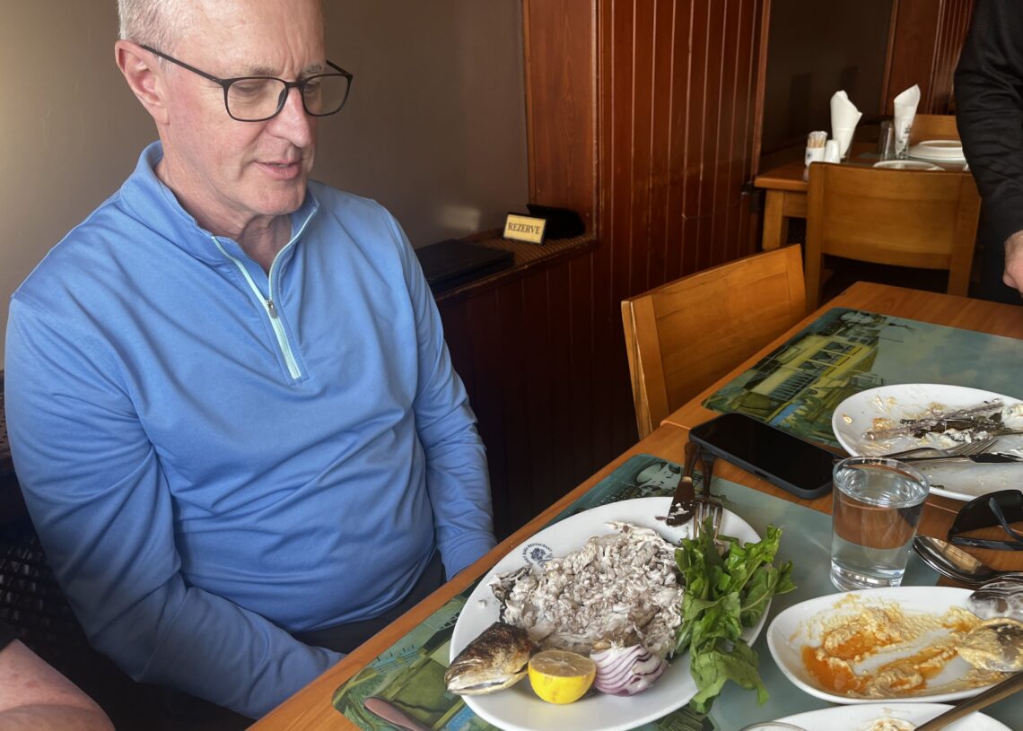Whole grilled levrek (European sea bass) served with lemon and fresh greens at İsmet Baba Restaurant in Istanbul