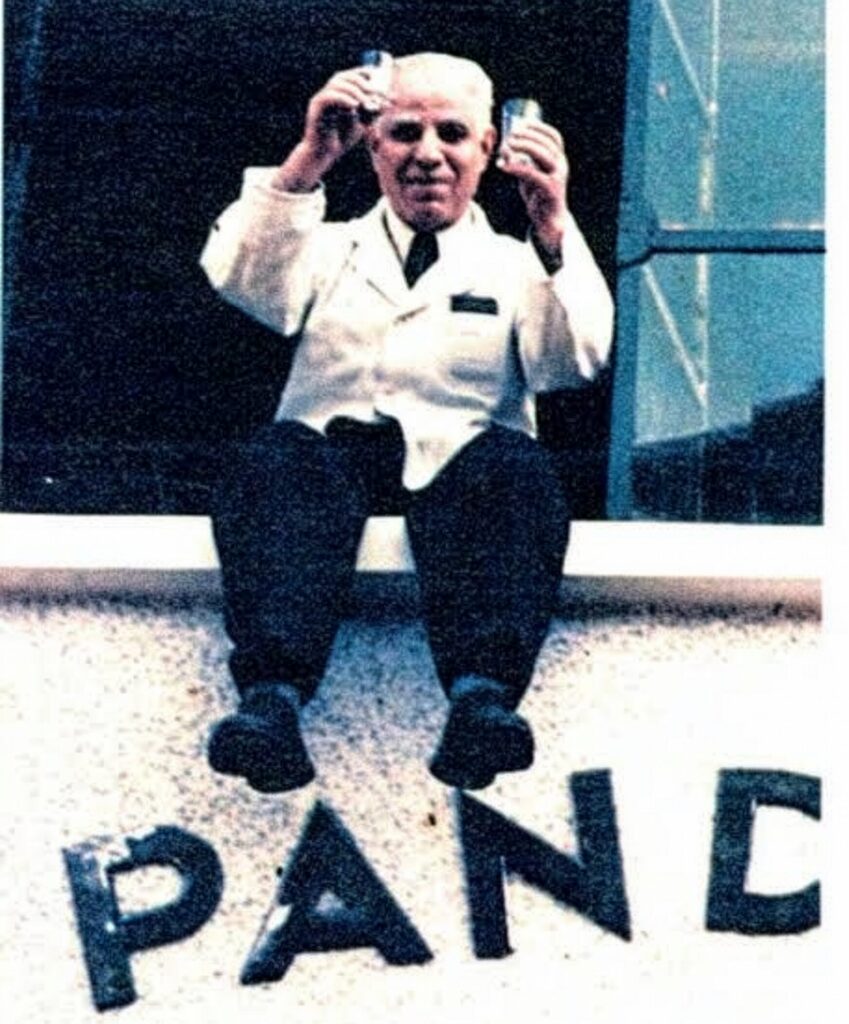 Pandeli Çobanoğlu, founder of Pandeli restaurant Istanbul, seated above the restaurant sign in a historic archive photograph
