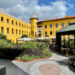 Four Seasons Hotel Istanbul at Sultanahmet's former prison courtyard with the watchtower, garden plantings and the glass-enclosed Avlu restaurant entrance