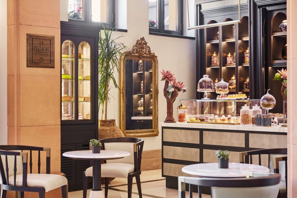 La Pistache Pâtisserie at Four Seasons Hotel Istanbul at Sultanahmet with glass cake display cases, marble counter, candy jars and gold-framed mirror