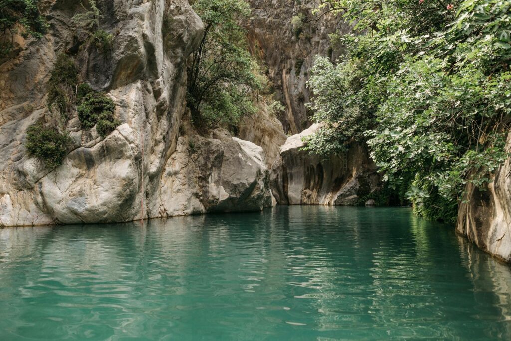 Emerald pool surrounded by limestone cliffs in Göynük Canyon near Kemer, Antalya, Turkey.