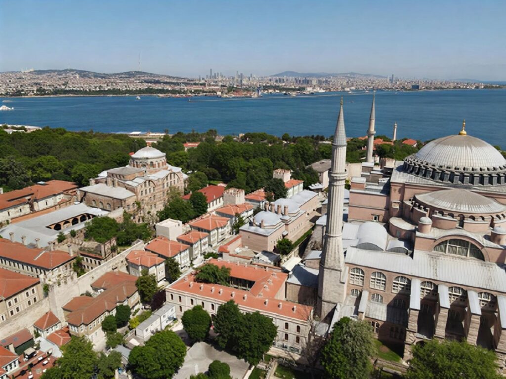 Aerial view of Hagia Sofia Mansions' courtyard directly behind Hagia Sophia in Sultanahmet, with the Bosphorus and Asian Istanbul in the background