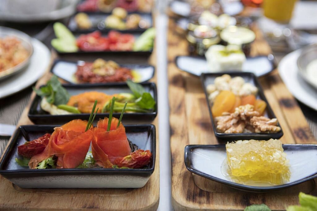 Turkish breakfast tasting boards at Hagia Sofia Mansions with smoked salmon, honeycomb, sundried tomatoes, fresh cheese and dried fruit, Sultanahmet Istanbul