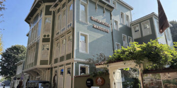 Hagia Sofia Mansions wooden mansion facade with hotel signage, ornate fretwork and golf cart at entrance on Kabasakal Caddesi, Sultanahmet Istanbul