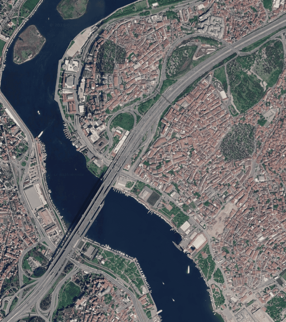 Satellite aerial view of Hasköy and the Golden Horn in Istanbul, showing the O-1 ring road running along the northern shore — the same highway was cut straight through the Jewish cemetery hillside in 1974