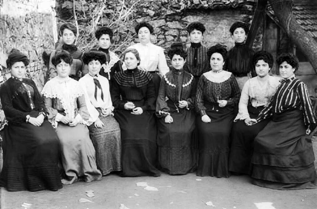 Historical black-and-white photograph of a group of women from the Hasköy Jewish community in Istanbul, posed together outdoors in late 19th or early 20th century dress
