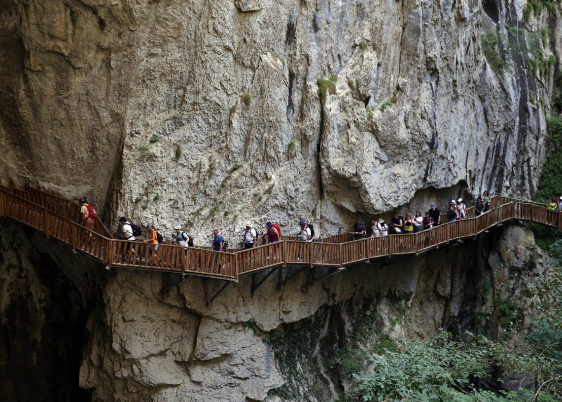 Visitors walking along the wooden boardwalk inside Horma Canyon in Kastamonu, Turkey.