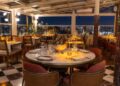 Elegant nighttime table setting at Manifest Roof Restaurant with champagne and illuminated Istanbul mosque skyline