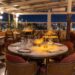 Elegant nighttime table setting at Manifest Roof Restaurant with champagne and illuminated Istanbul mosque skyline