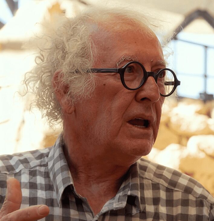 Murat Akman, archaeologist and site custodian at Çayönü Tepesi, photographed speaking at an indoor venue