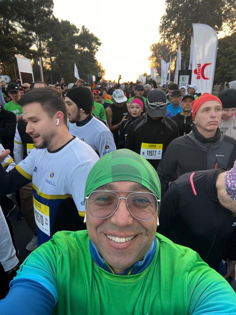 Orçun Kamit taking a selfie among runners at the start of the Samarkand Marathon.