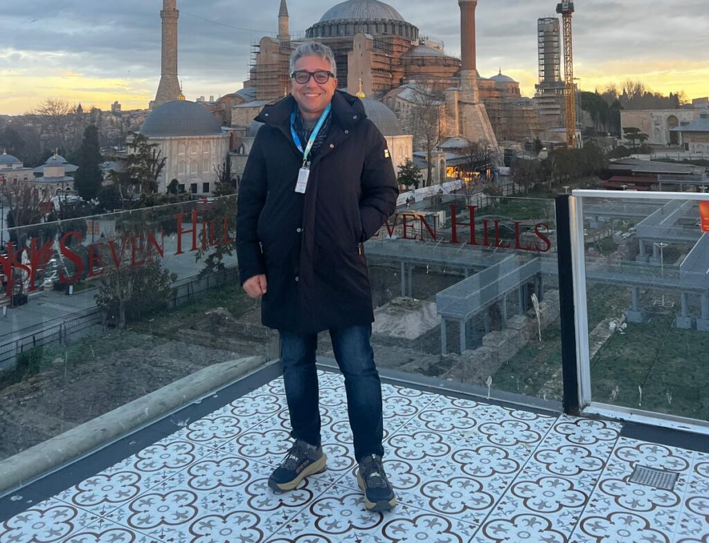 Orçun Kamit standing in front of Hagia Sophia in Sultanahmet, Istanbul, with the historic skyline in the background.