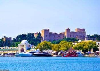 The Palace of the Grand Master of the Knights of Rhodes rising above the medieval harbour, visible from the sea as the ferry from Marmaris approaches — built by the same Hospitaller crusaders who constructed Bodrum castle across the strait