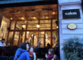 Salon Galata at dusk — glowing wooden facade and sidewalk tables on Bankalar Caddesi, Karaköy