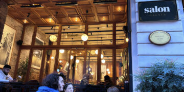 Salon Galata at dusk — glowing wooden facade and sidewalk tables on Bankalar Caddesi, Karaköy