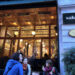 Salon Galata at dusk — glowing wooden facade and sidewalk tables on Bankalar Caddesi, Karaköy