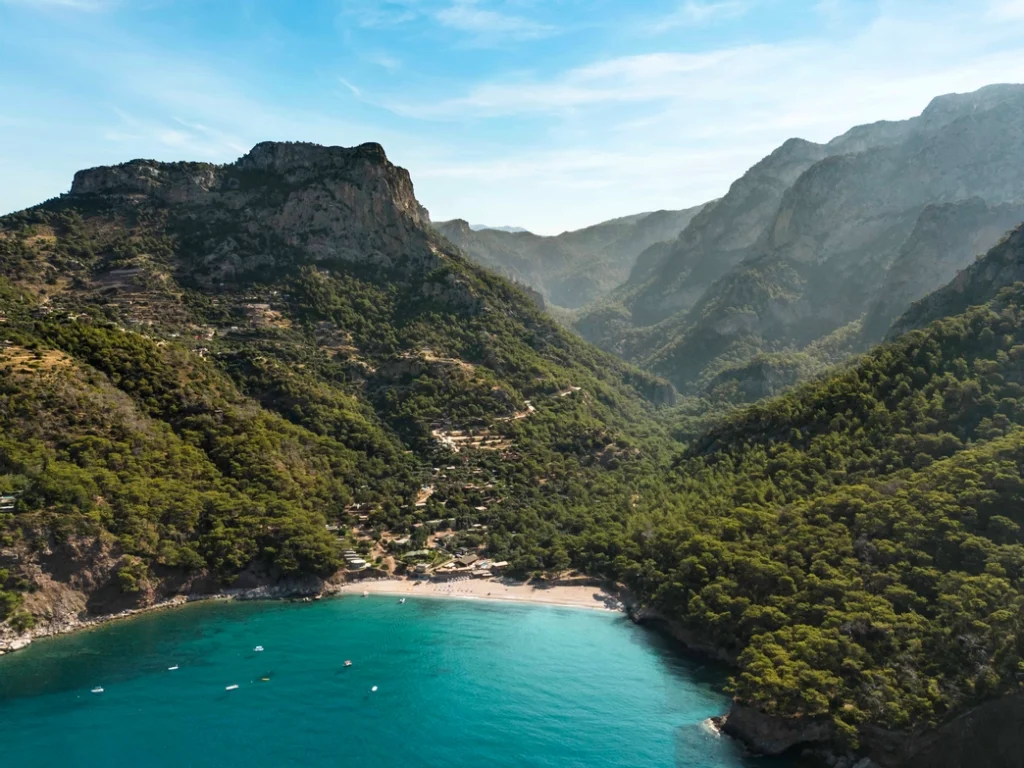 Panaromic view of Kabak Valley surrounded by forested mountains and the Mediterranean coast near Fethiye, türkiye.