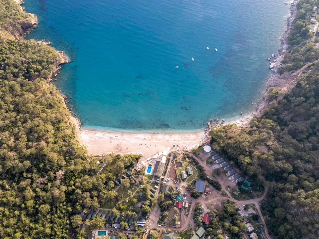Bird's-eye view of Kabak Beach with turqoise water and the surronding coastline in Kabak Valley near Fethiye, Türkiye.