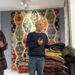 Visitors exploring traditional Anatolian kilims at Kirkit Rugs in Sultanahmet, Istanbul, surrounded by handcrafted Turkish flatweaves and symbolic woven motifs.