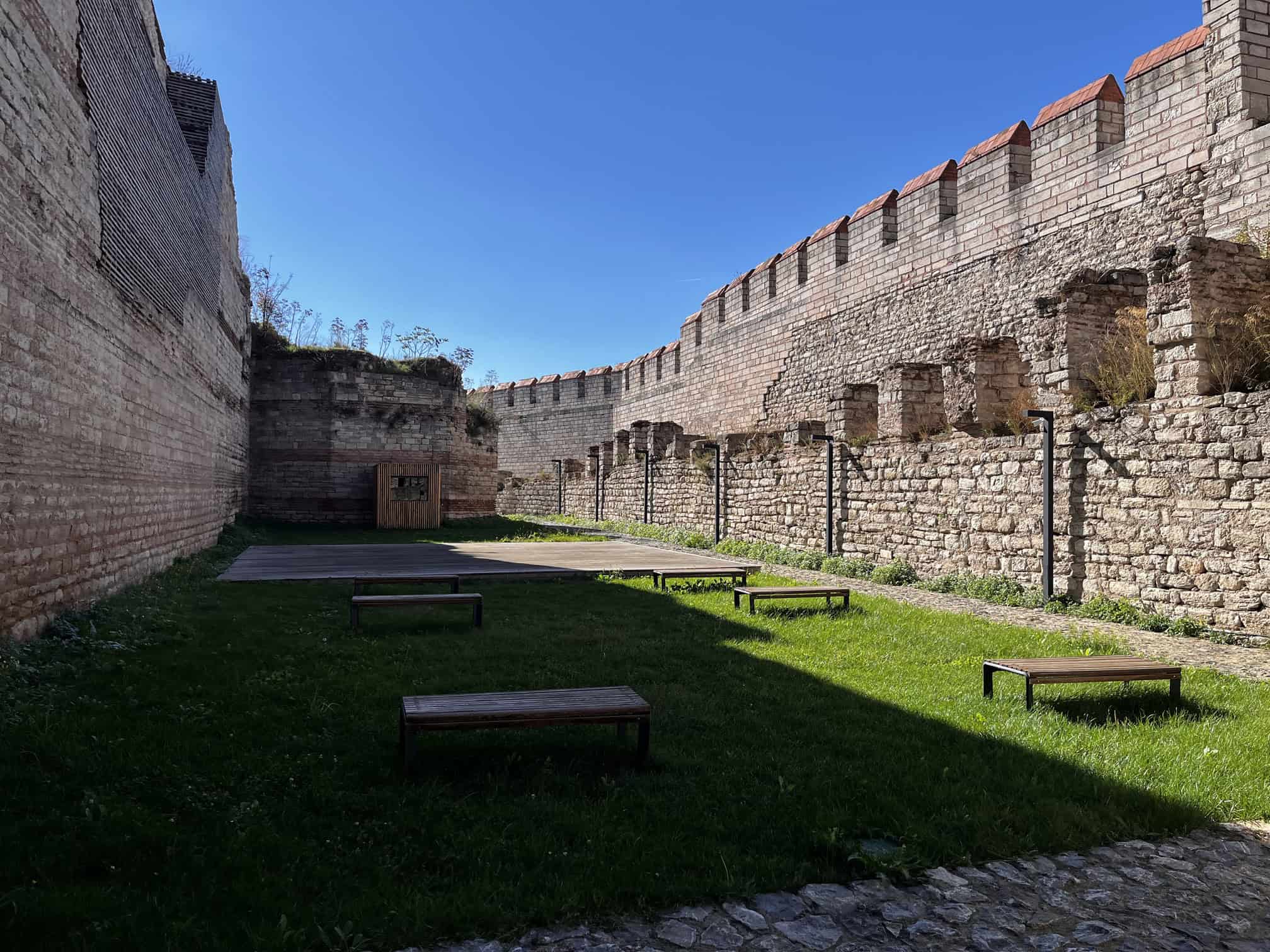 A long run of the Theodosian land walls at Mevlanakapi with the moat lawn in front