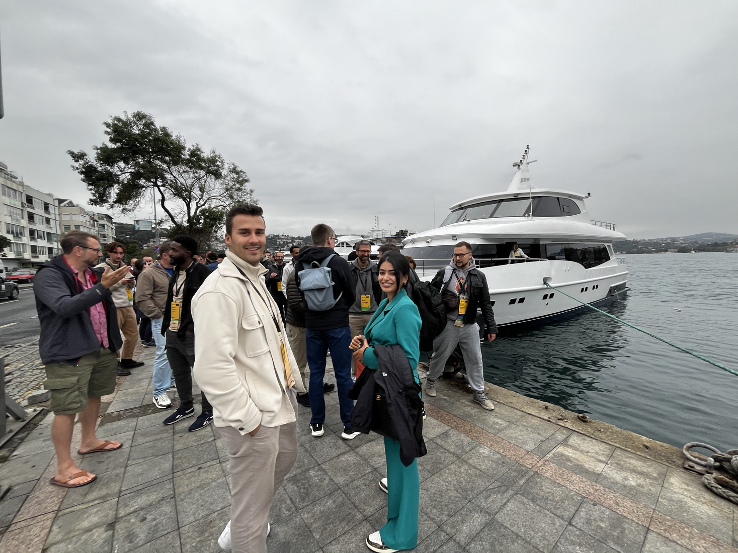 A conference group waiting on the quay to board a private yacht