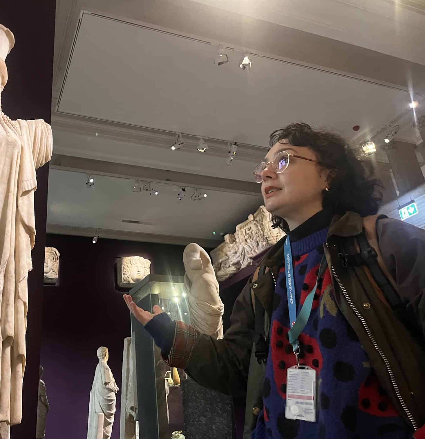 Zeynep Karakaşoğlu guiding in a museum gallery of marble statues