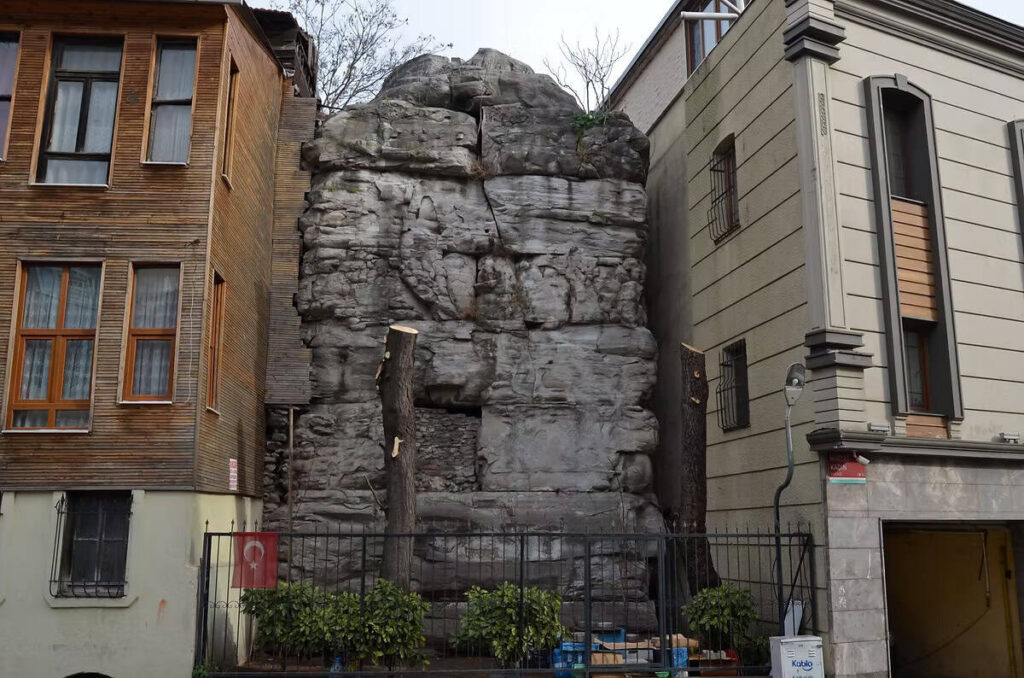 Massive surviving stone base of the Column of Arcadius between apartment buildings