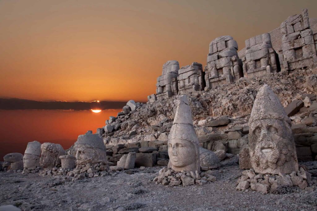 Colossal stone heads on the summit of Mount Nemrut at sunrise